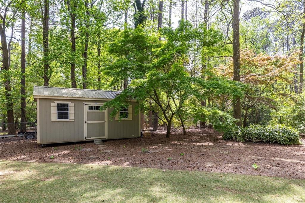 2282 Marthasville Court Smoke Rise, GA 30087 - Photo 45 of 48 a view of a house with a tree in the background