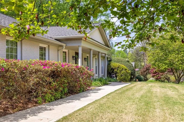 a front view of a house with a garden