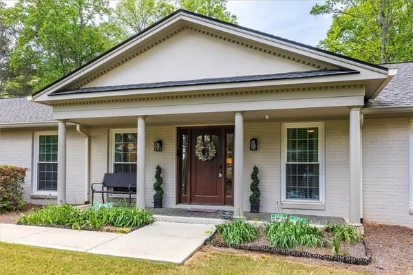 a front view of a house with garden