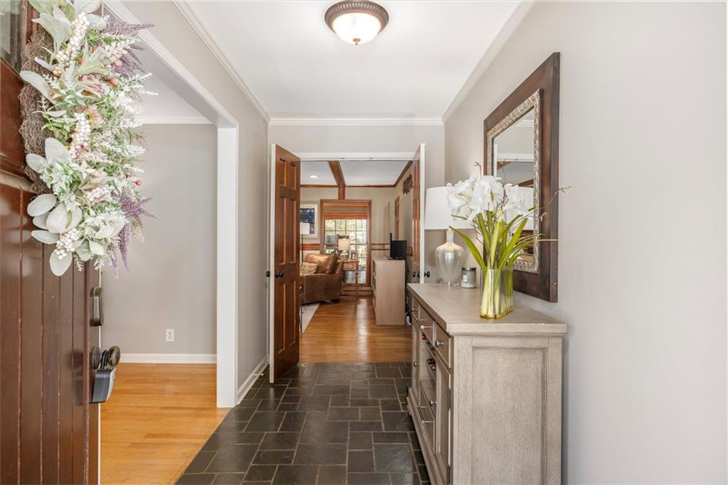2282 Marthasville Court Smoke Rise, GA 30087 - Photo 7 of 48 a hallway with painting and a potted plant