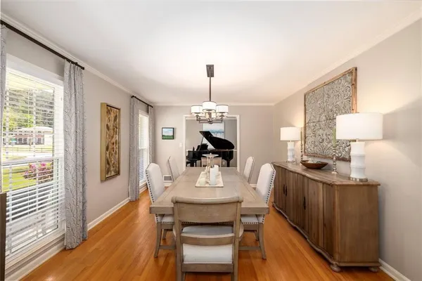 a dining room with furniture and wooden floor