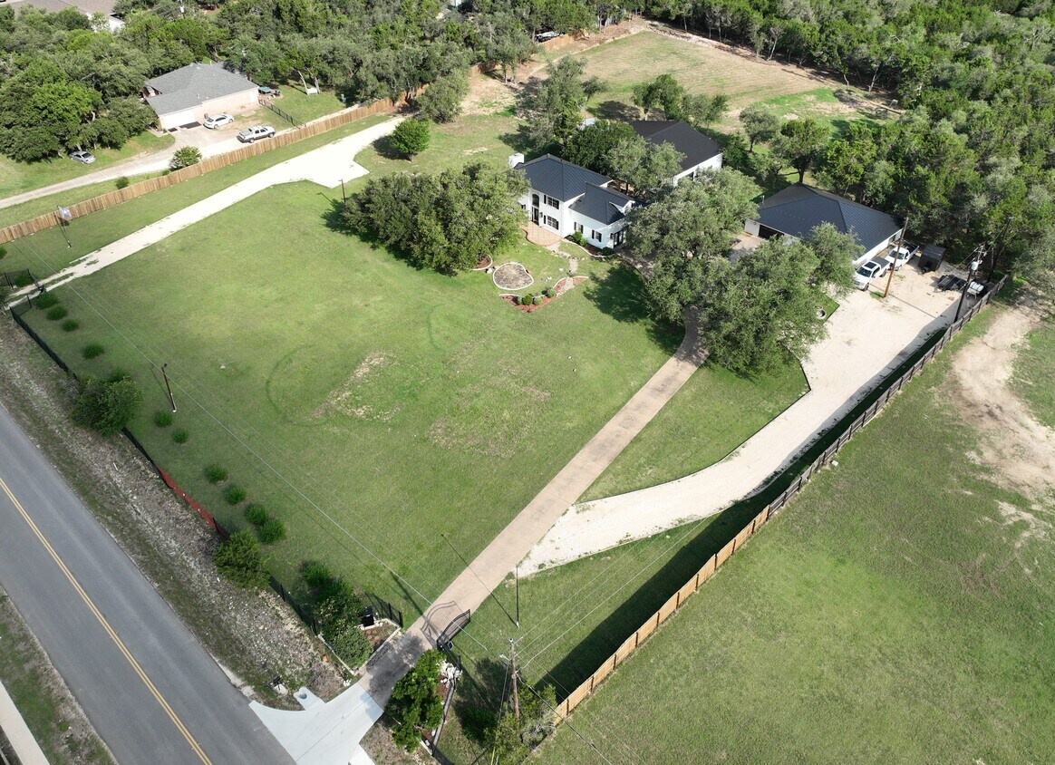 102 County Road 180 Leander, TX 78641 - Photo 3 of 25 An aerial perspective reveals a vast estate with a long private driveway leading to the main residence.