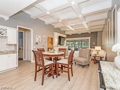 a dining room with furniture and wooden floor
