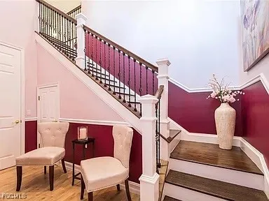 a view of entryway dining room and hall with wooden floor