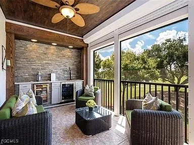 a balcony with furniture and a potted plant