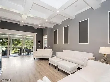 a living room with furniture and large windows