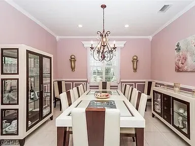 a view of a dining room with furniture a rug and wooden floor
