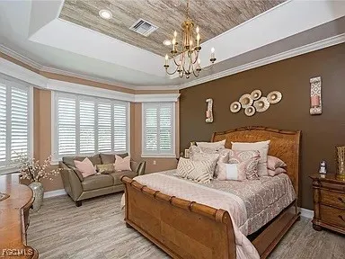 a bedroom with a large bed and a couch