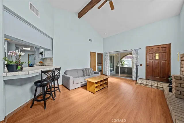 a kitchen with stainless steel appliances granite countertop a lot of counter space and wooden floors