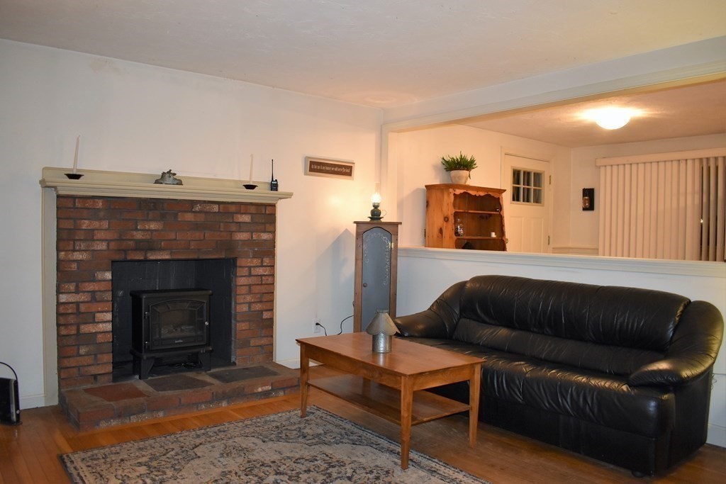 1702 State Road Plymouth, MA 02360 - Photo 4 of 17 a living room with furniture and a fireplace