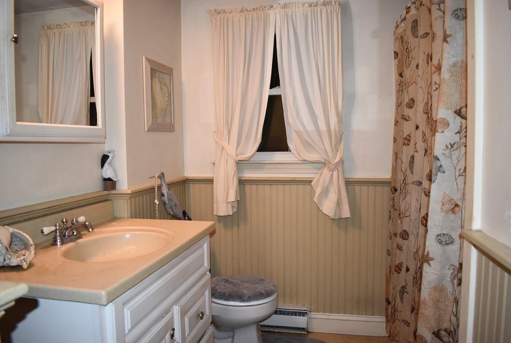 1702 State Road Plymouth, MA 02360 - Photo 9 of 17 a bathroom with a granite countertop sink and a toilet
