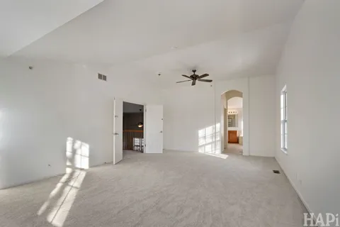 an empty room with windows and closet