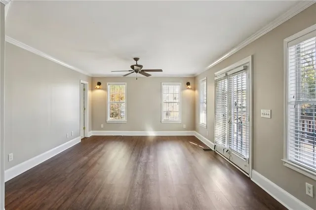 a view of room with hardwood floor and hallway