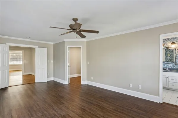 a view of room with hardwood floor and hallway