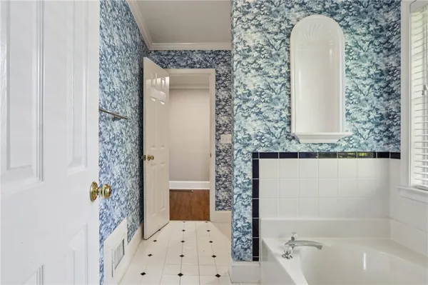 a bathroom with a granite countertop sink a mirror and shower