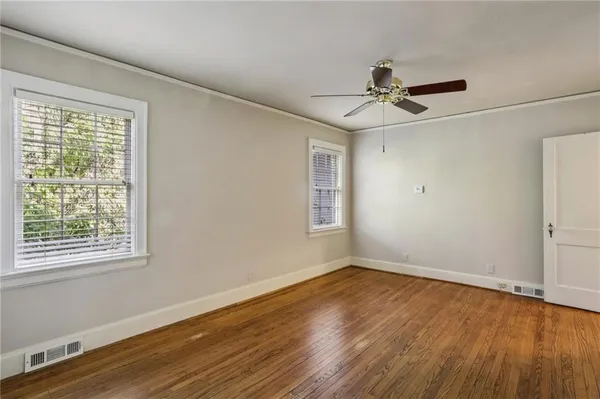 wooden floor in an empty room with a window