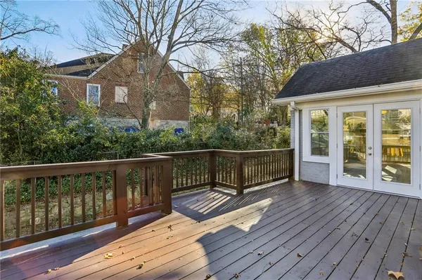 a view of a wooden deck with a yard