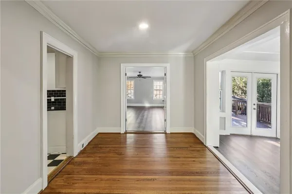 a view of empty room with wooden floor