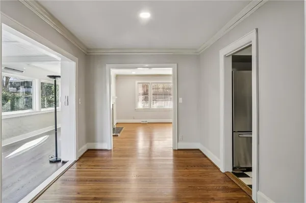 a view of an entryway of a house and wooden floor in a room
