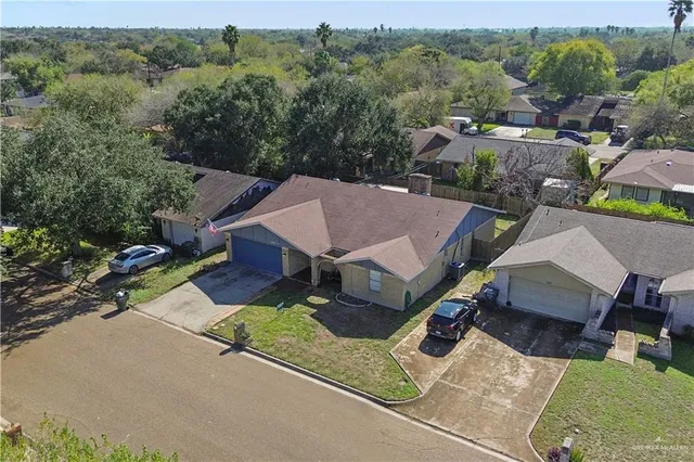 an aerial view of a house with yard swimming pool and outdoor seating