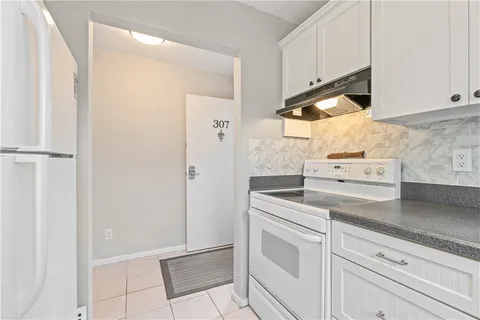 a white refrigerator freezer sitting inside of a kitchen