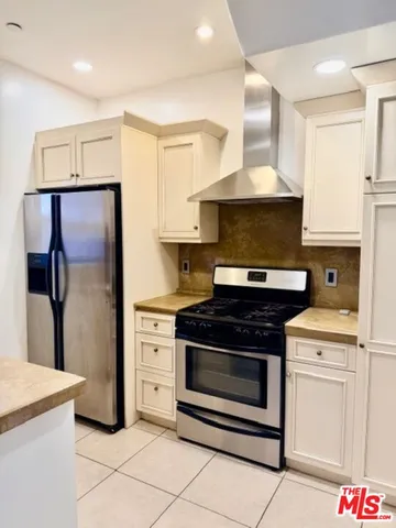 a stove top oven sitting inside of a kitchen