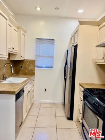 a kitchen with a sink stove and refrigerator