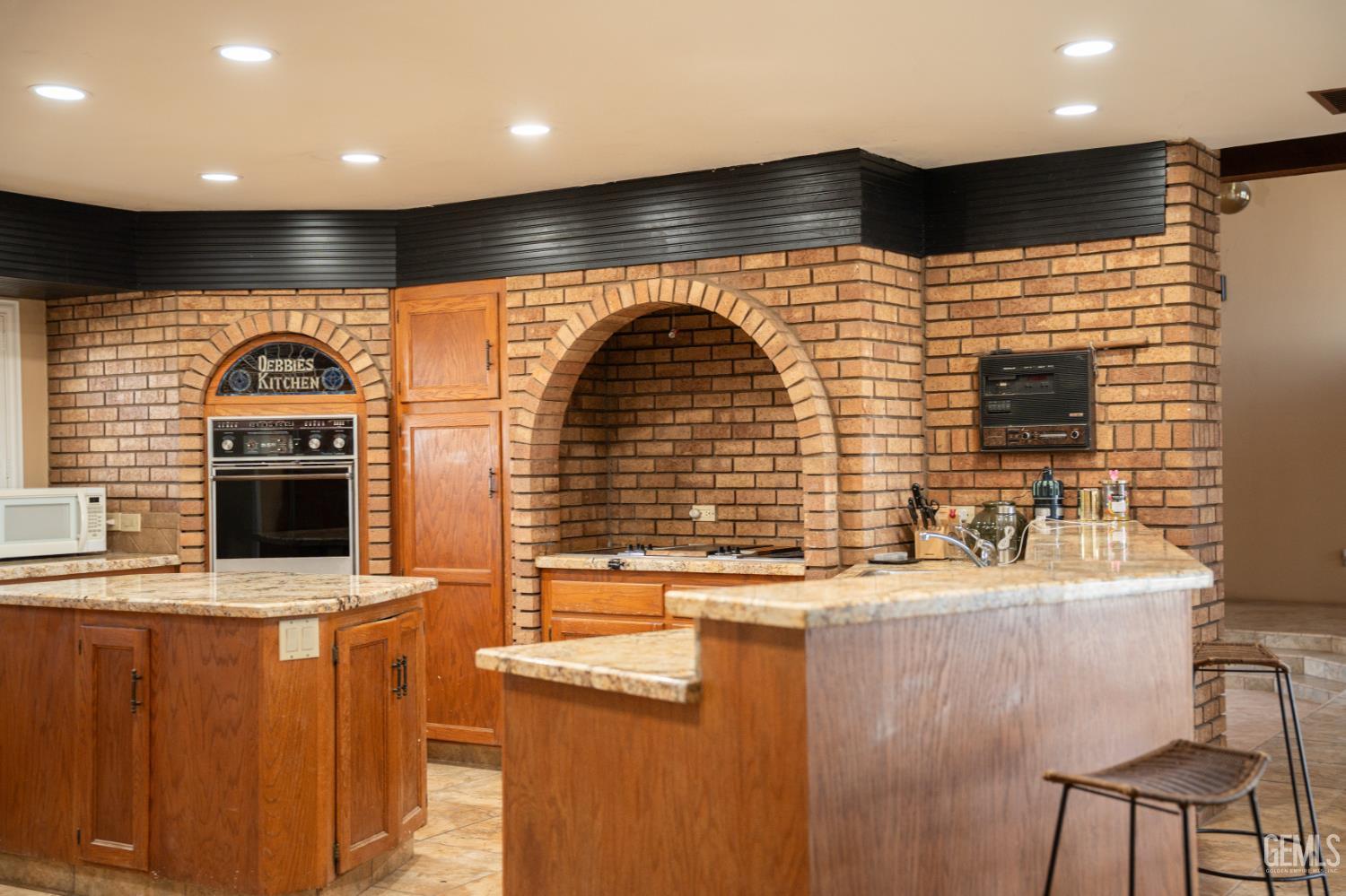 Undisclosed Address Bakersfield, CA 93308 - Photo 17 of 29 a kitchen with stainless steel appliances kitchen island a stove and a sink