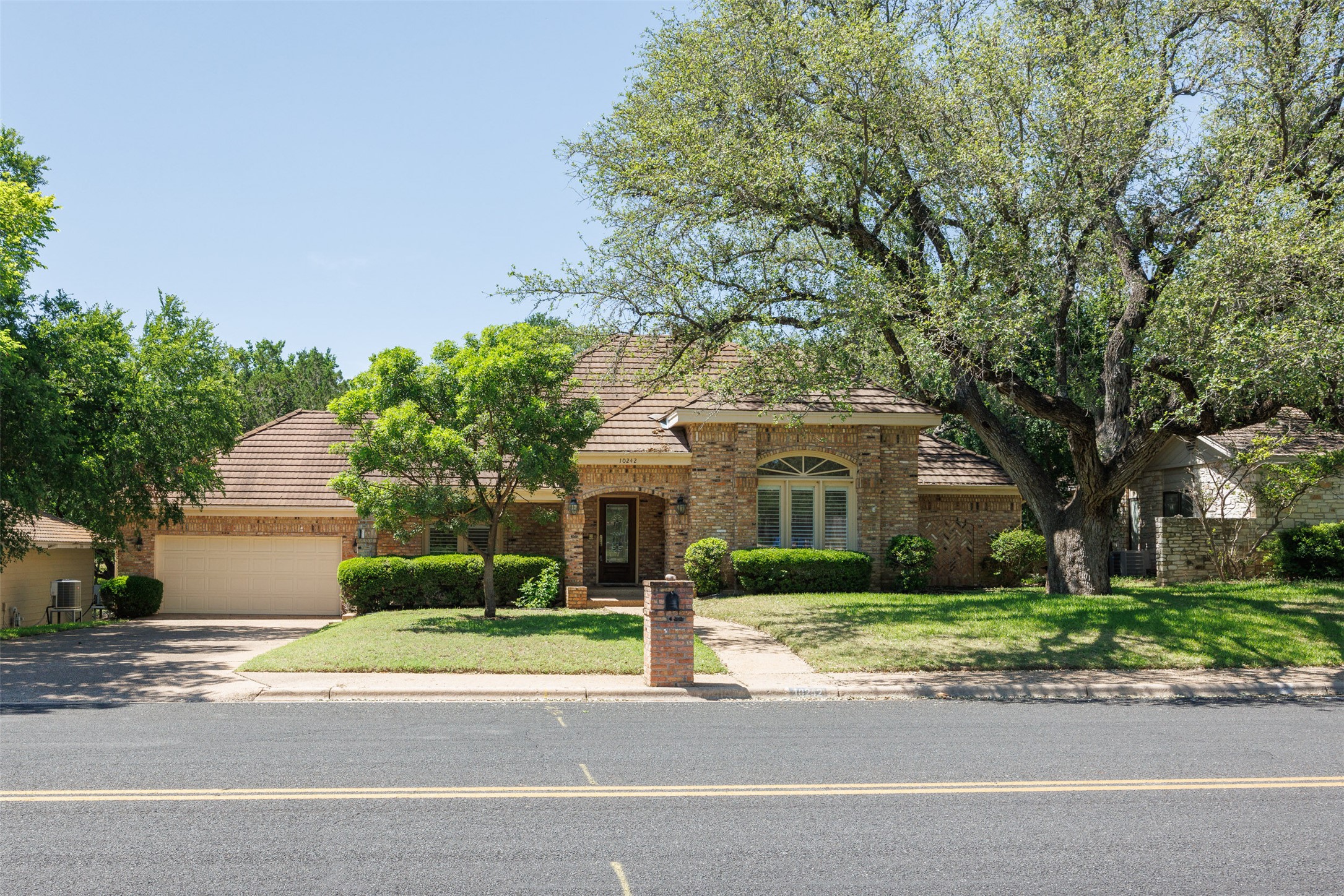 View of front with a tiled roof concrete driveway, an attached 2 car garage,