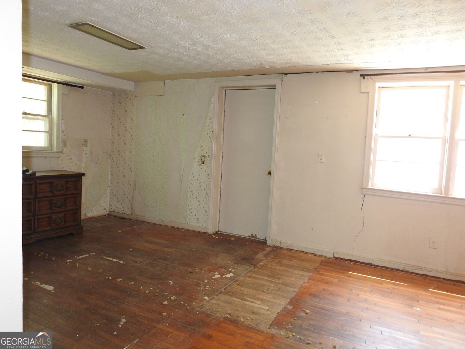 333 Lickskillet Road Epworth, GA 30541 - Photo 31 of 38 a view of an empty room with wooden floor and a window