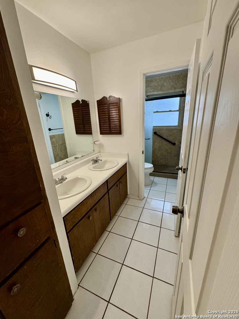 146 Stapleton Street San Antonio, TX 78227 - Photo 15 of 28 a kitchen with a sink a stove top oven and cabinets