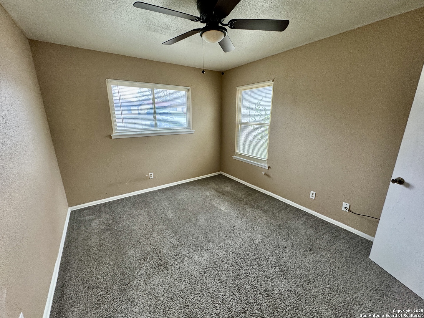 146 Stapleton Street San Antonio, TX 78227 - Photo 17 of 28 an empty room with windows and fan