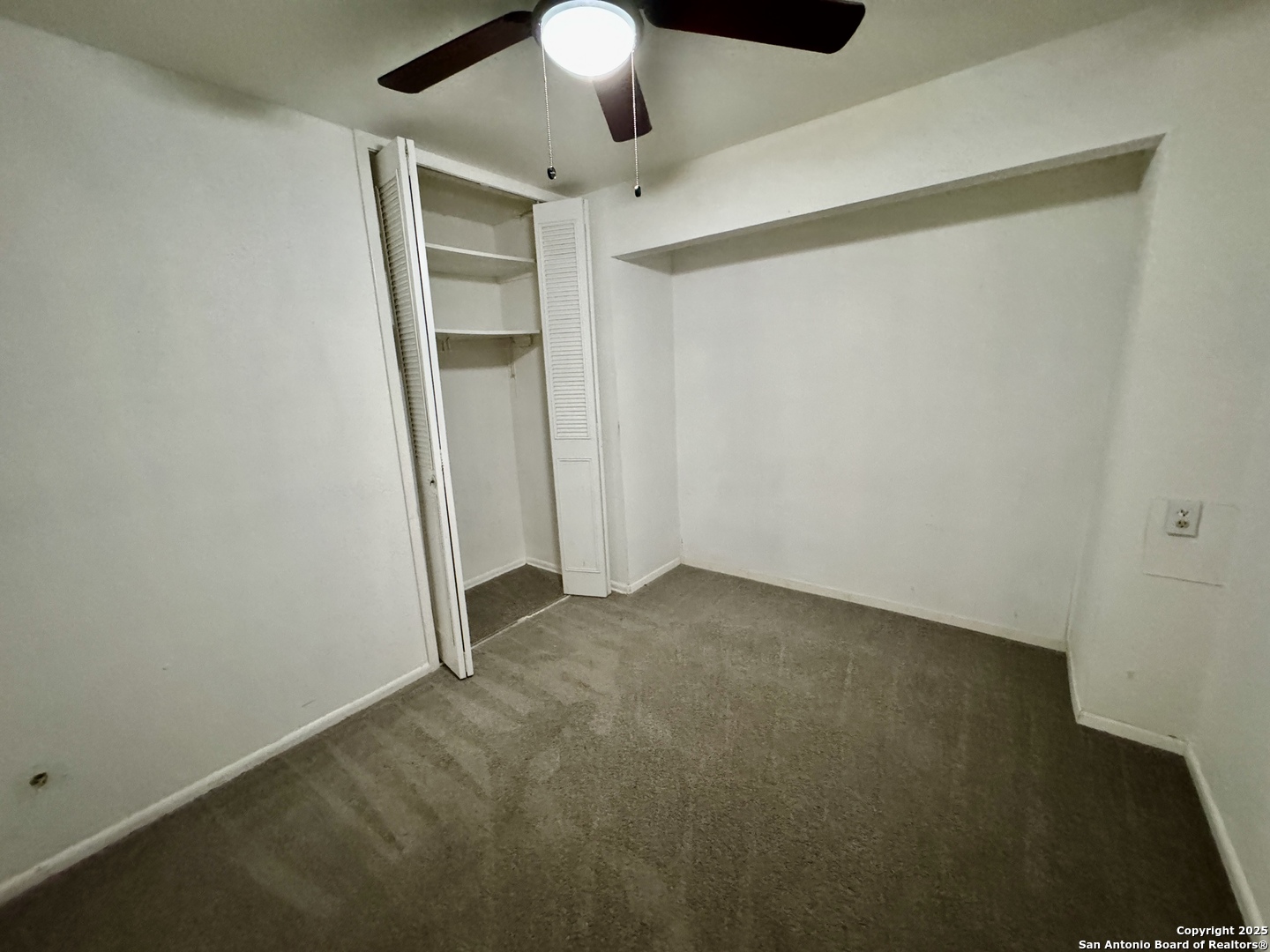 146 Stapleton Street San Antonio, TX 78227 - Photo 22 of 28 an empty room with a ceiling fan and carpet