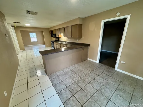 a large white kitchen with a sink