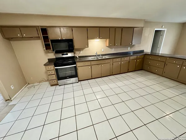 a kitchen with stainless steel appliances a sink and cabinets