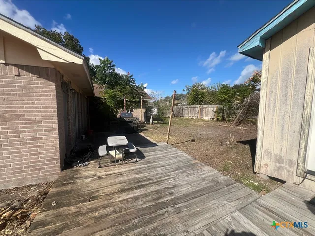 a view of a backyard with sitting area