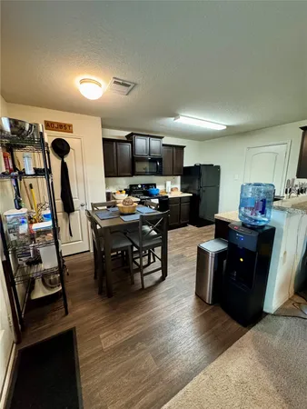 a kitchen with a sink cabinets and wooden floor