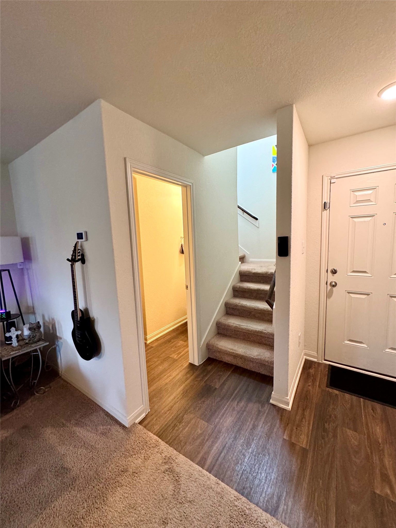 205 Denson Lane, Unit 8D Jarrell, TX 76537 - Photo 11 of 29 an empty room with wooden floor and white walls
