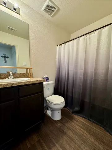 a bathroom with a toilet a sink and a mirror