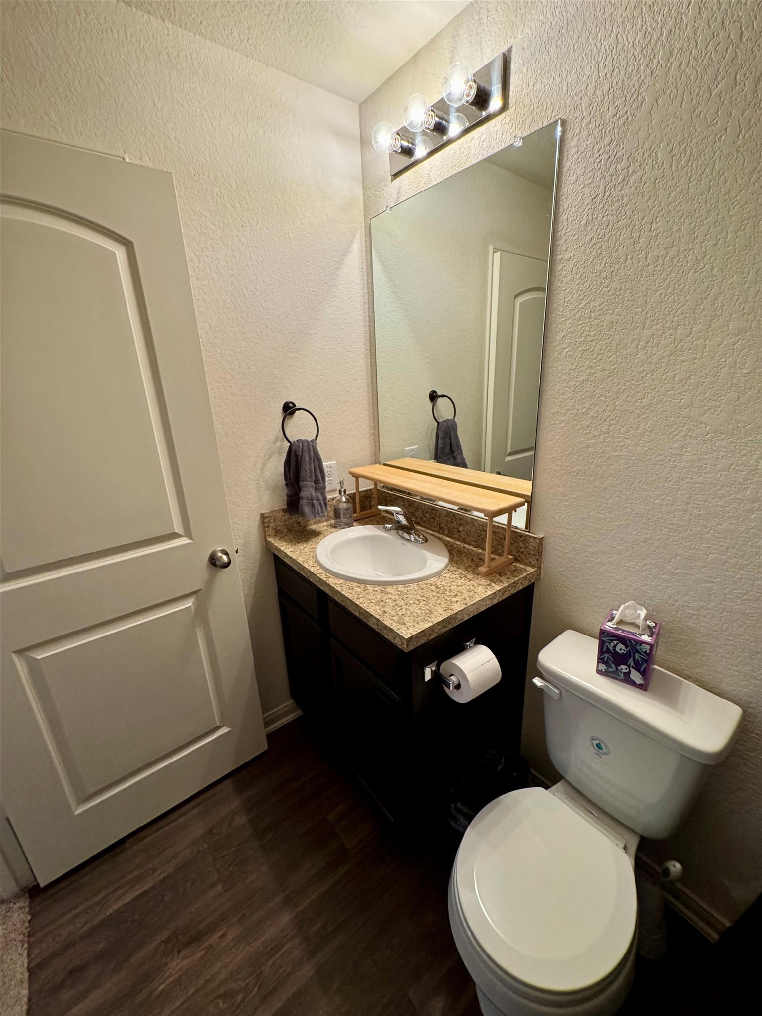 205 Denson Lane, Unit 8D Jarrell, TX 76537 - Photo 16 of 29 a bathroom with a toilet a sink and a mirror