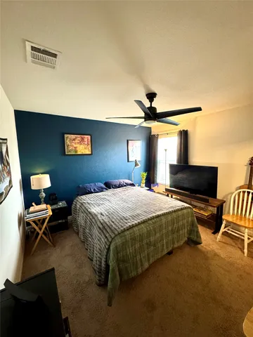 a bedroom with a bed and a mirror