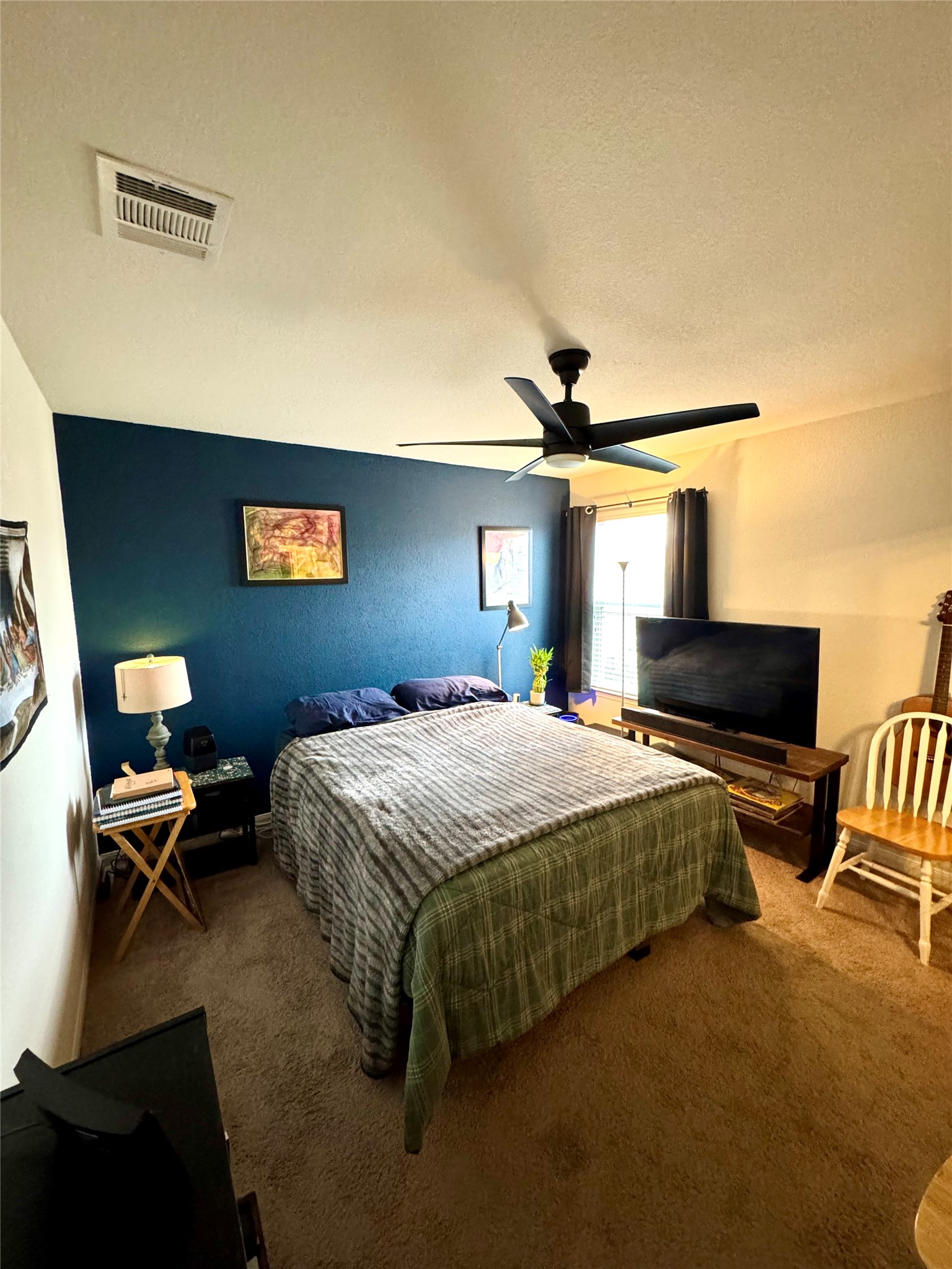 205 Denson Lane, Unit 8D Jarrell, TX 76537 - Photo 19 of 29 a bedroom with a bed and wooden floor