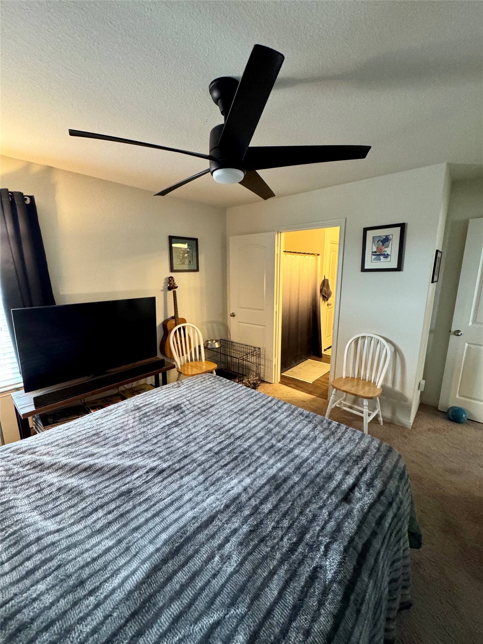 205 Denson Lane, Unit 8D Jarrell, TX 76537 - Photo 21 of 29 a bedroom with a bed and wooden floor