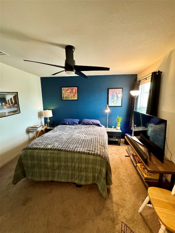 205 Denson Lane, Unit 8D Jarrell, TX 76537 - Photo 22 of 29 a bedroom with a bed and dresser with rug