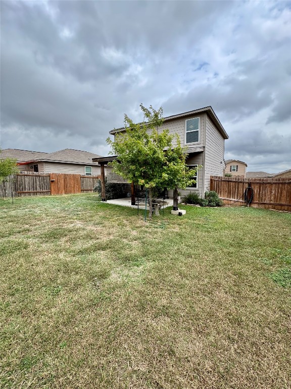 205 Denson Lane, Unit 8D Jarrell, TX 76537 - Photo 26 of 29 a backyard of a house with table and chairs