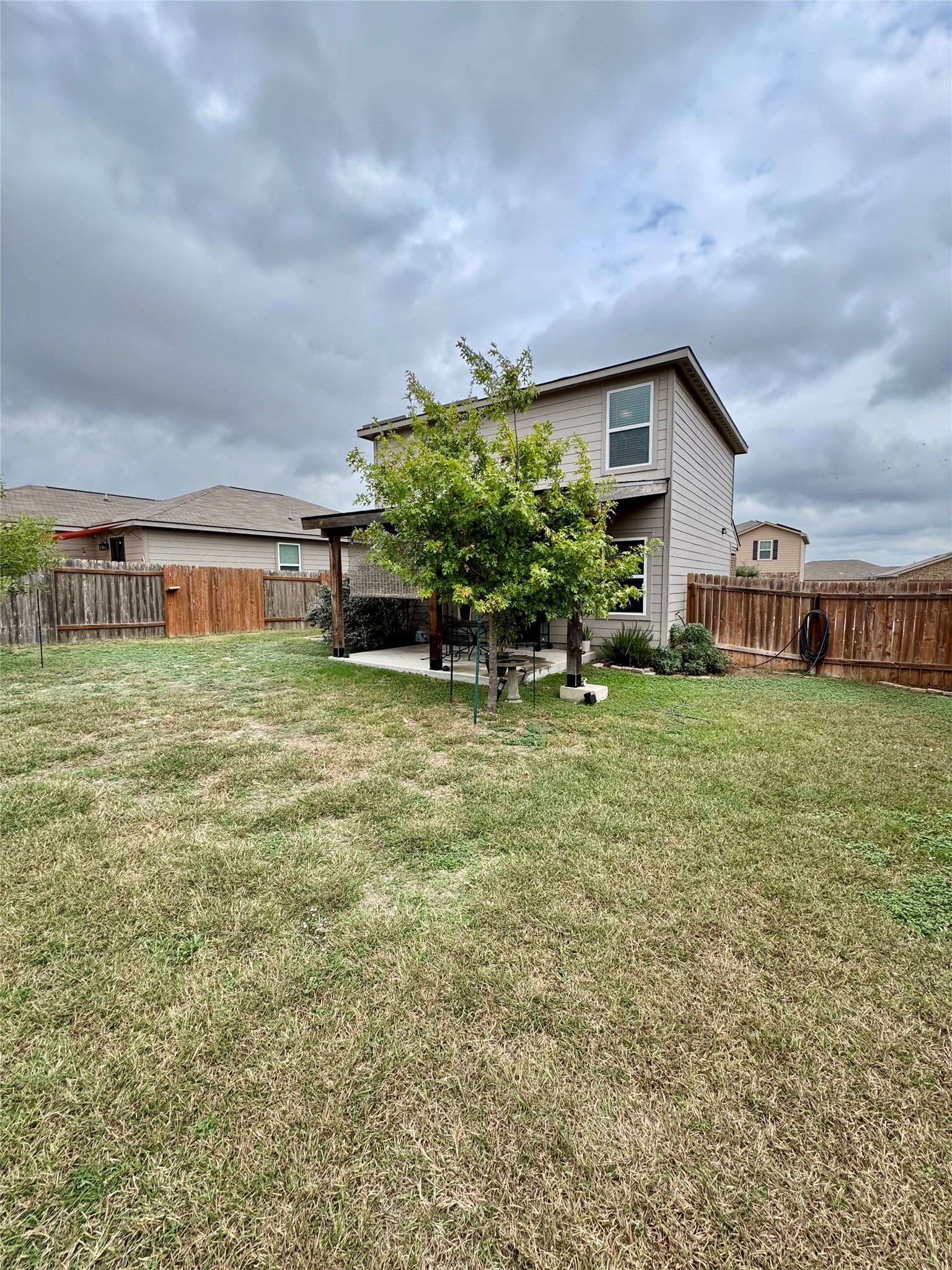 205 Denson Lane, Unit 8D Jarrell, TX 76537 - Photo 26 of 29 a backyard of a house with table and chairs