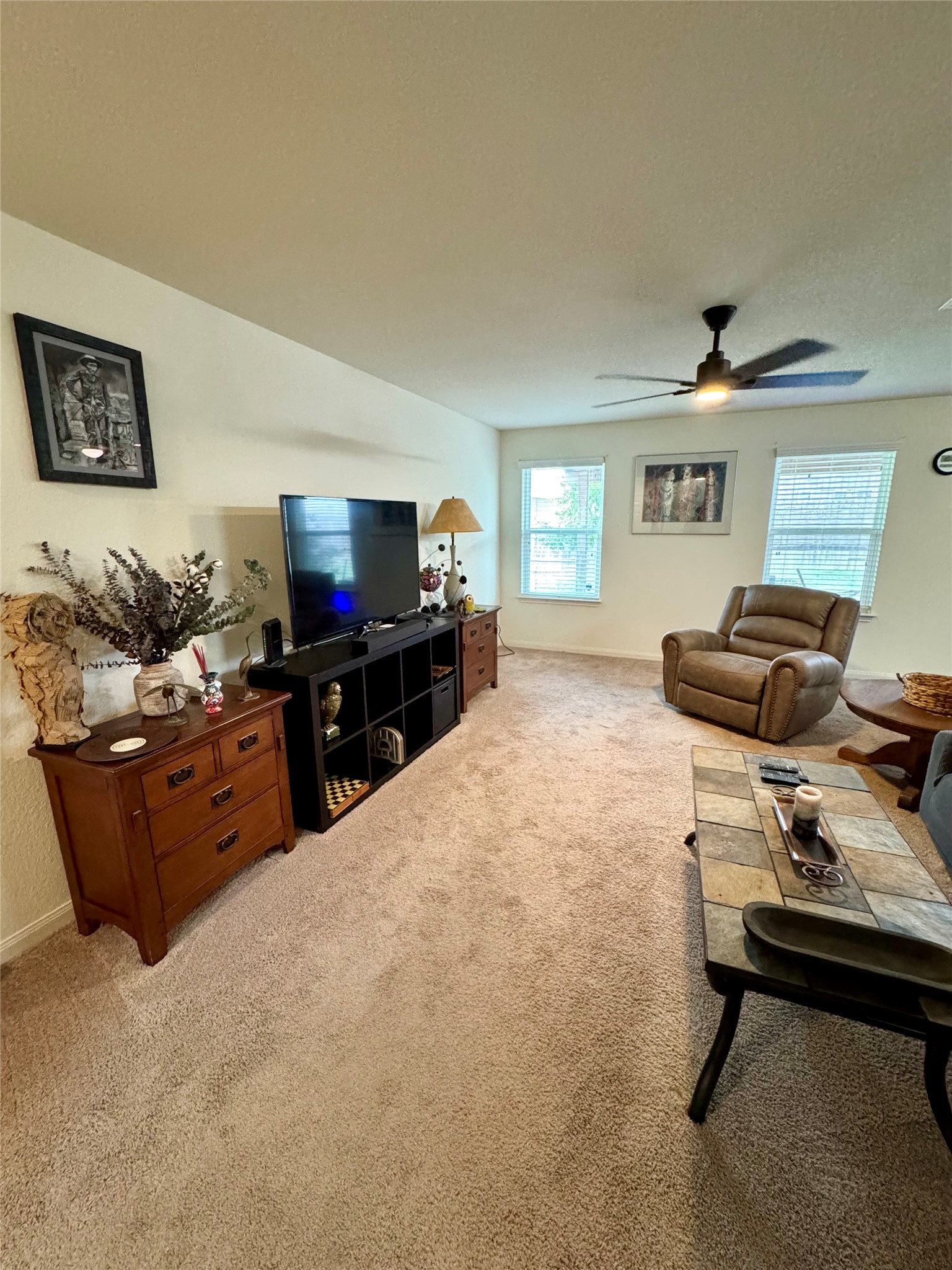 205 Denson Lane, Unit 8D Jarrell, TX 76537 - Photo 5 of 29 a living room with furniture and a flat screen tv