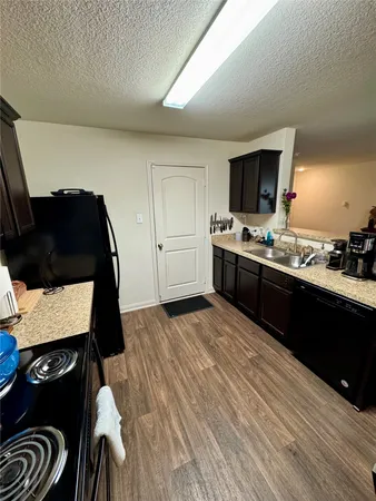 a kitchen with a sink and a stove top oven