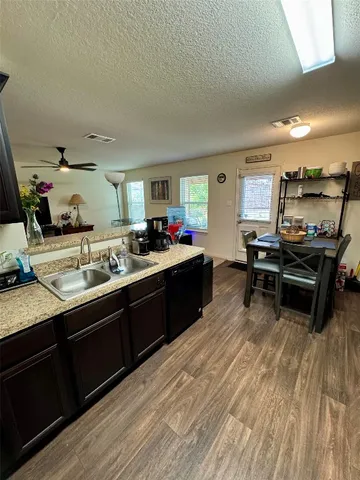 a kitchen with granite countertop a sink and cabinets