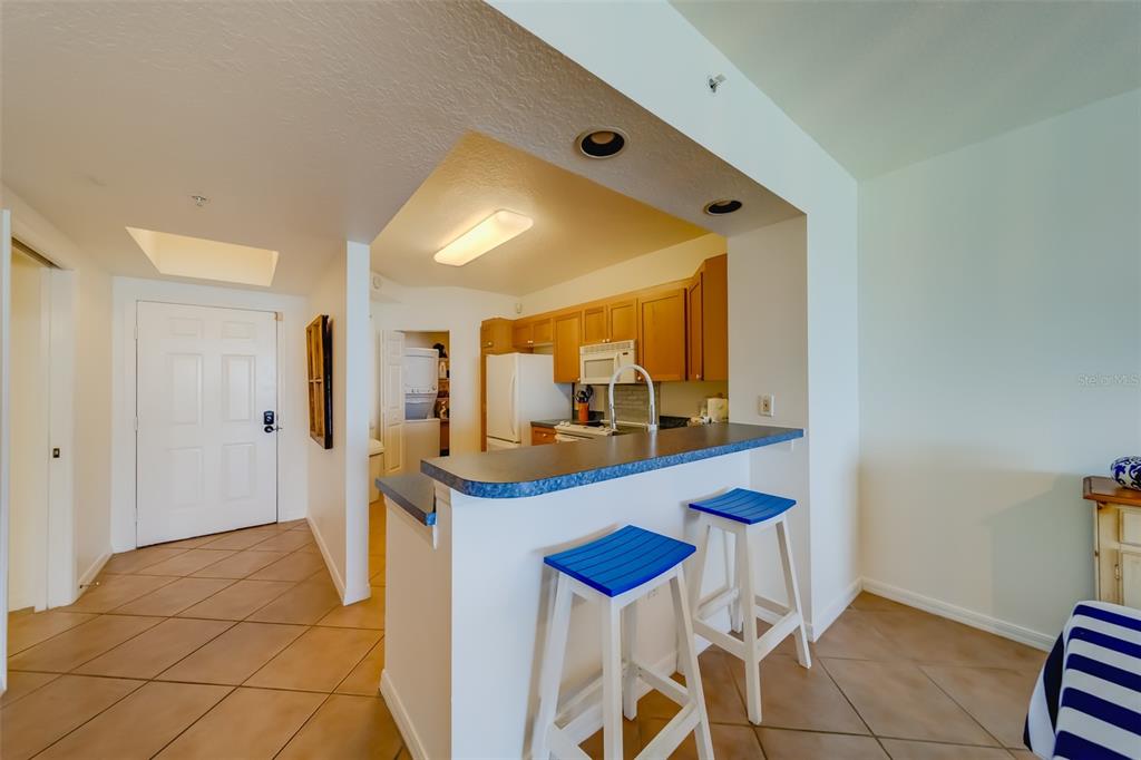 16550 Gulf Boulevard, Unit 643 North Redington Beach, FL 33708 - Photo 15 of 67 a dining room with a sink and a mirror